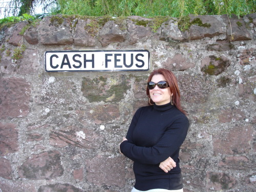 This is a street sign in the town of Strathmiglo, Fife, Scotland,
where my family on my dad’s side originated in the 11th century.
There are still a few things with the name of Cash scattered around this part of Fife:  Cash Mill, Cash Farm, Cash Easter and Cash Wester, and this street, Cash Feus.  It’s odd— and comforting— to know that my ancestors lived here for hundreds of years, until one of them decided to move to America in the 17th century.  I don’t even know what they passed on to me— perhaps a love of melancholy, Celtic- rooted music?  A love of rolling hills and crumbling stone walls?
Maybe even the red hair.